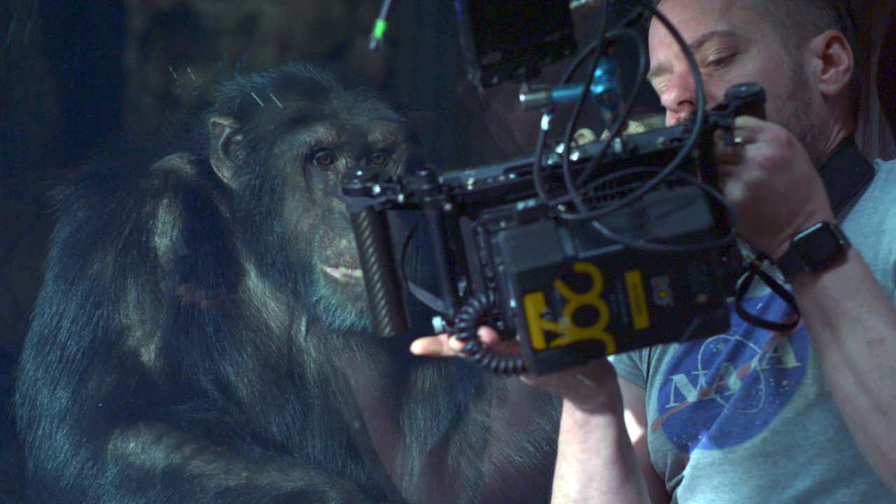 a man filming a chimp